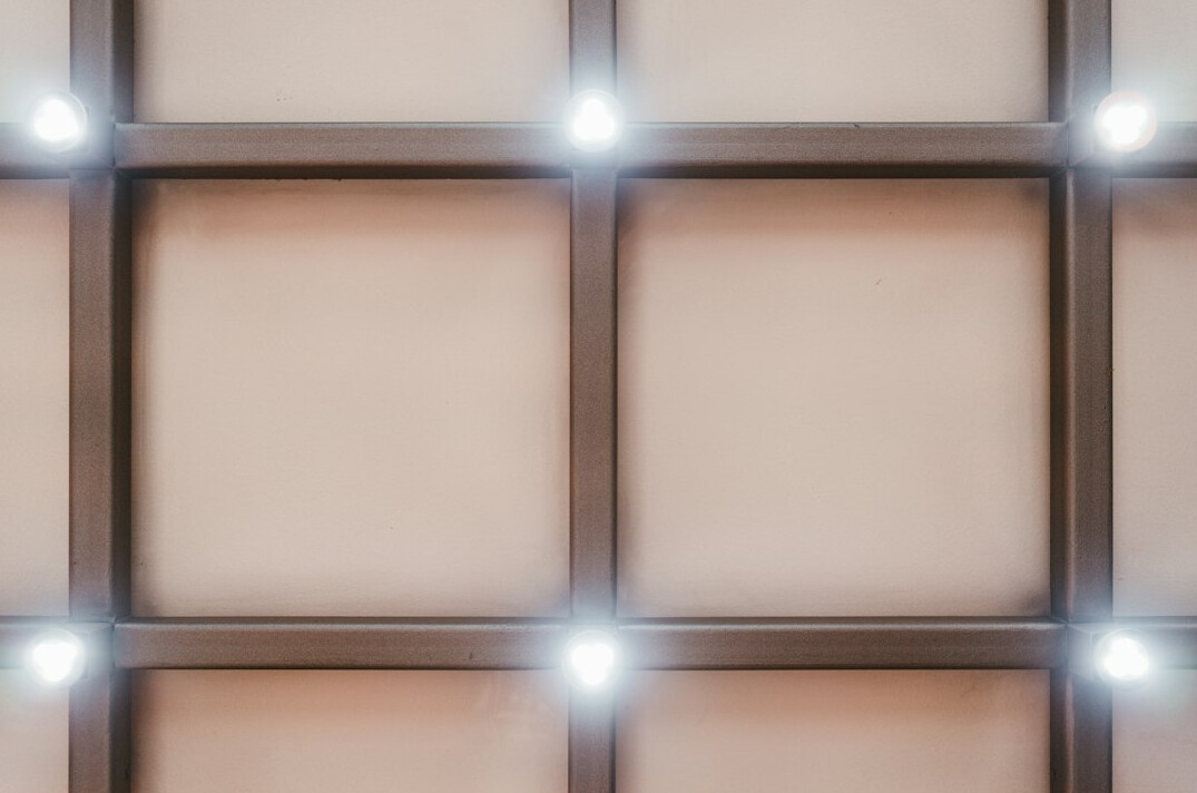 Studio lighting rig with spotlights above a news desk